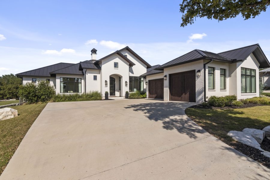 Single‑story custom home on one acre with oak trees and covered outdoor living space